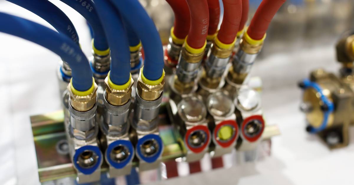 Six blue rubber air hoses and six red rubber air hoses, each paired with brass pneumatic air fittings.