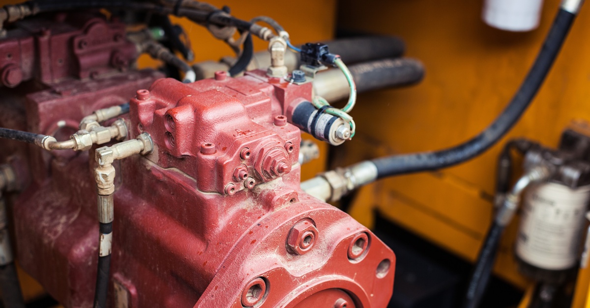 An industrial motor attached to other components of an industrial equipment system installed in a bulldozer.