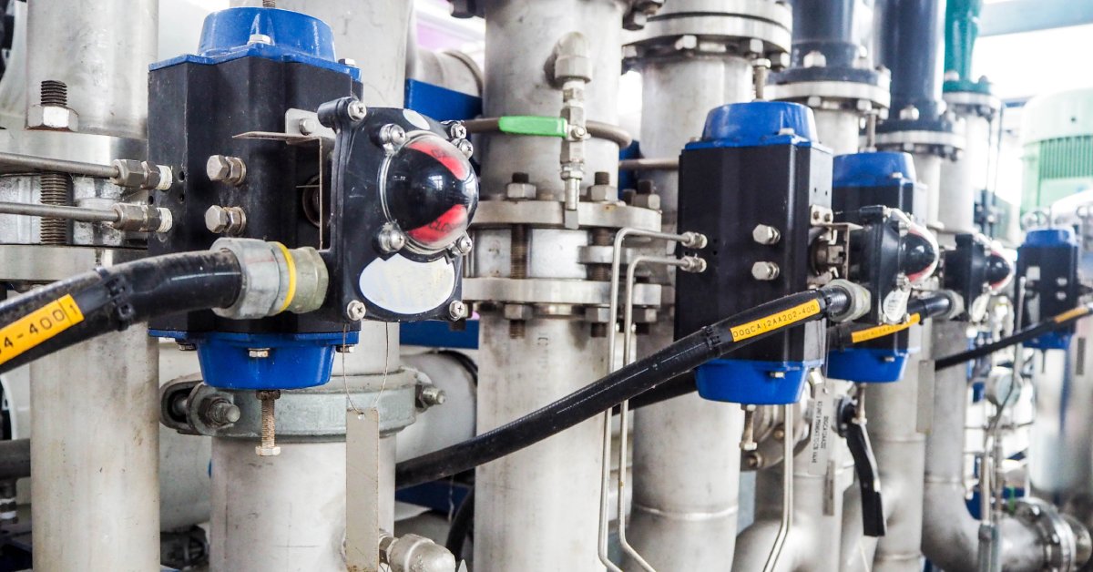 A pneumatic valve with on-off control operated by a pneumatic actuator installed in an industrial worksite.